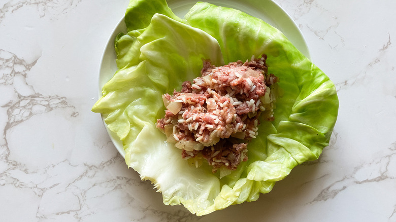 Photo of cabbage roll and rice and meat mixture