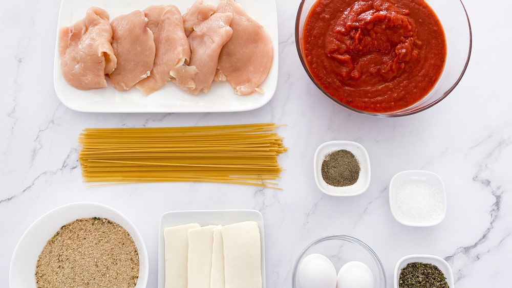 raw chicken breasts, pasta sauce, spaghetti noodles, eggs, Italian seasoning, mozzarella cheese, bread crumbs