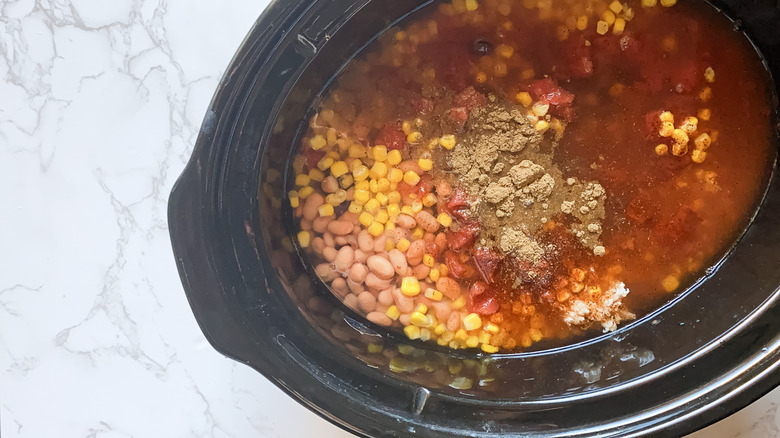 Slow cooker chicken taco chili in crockpot with spices 