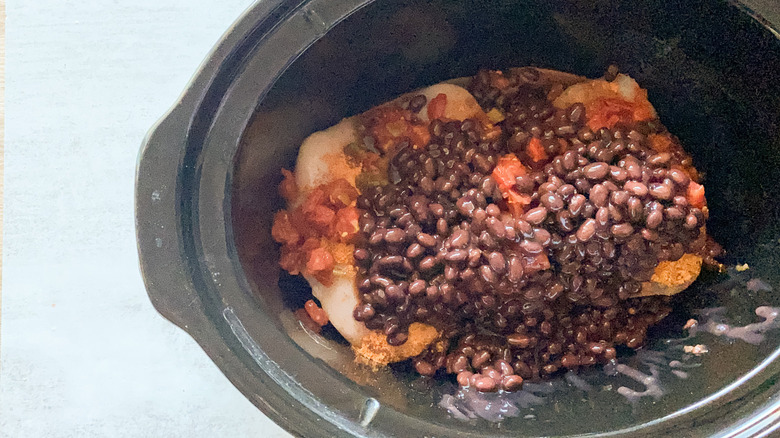 chicken, beans, Rotel, and seasoning in crock pot