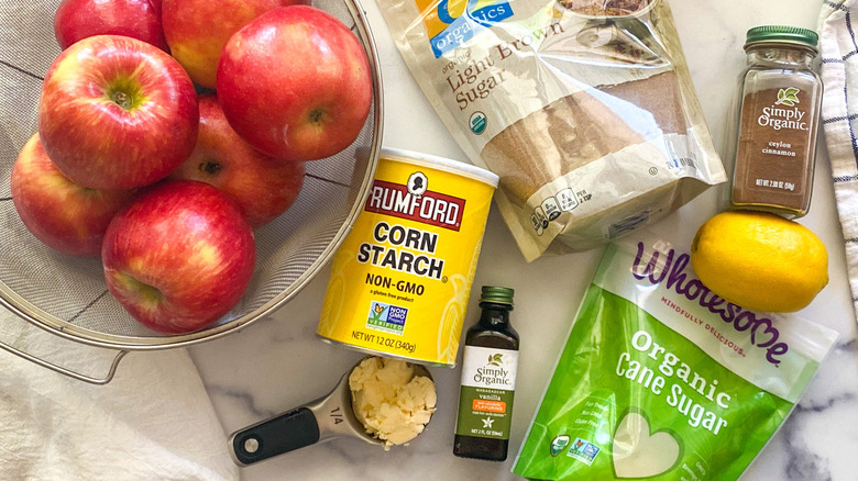 Apples and other ingredients sitting on a countertop