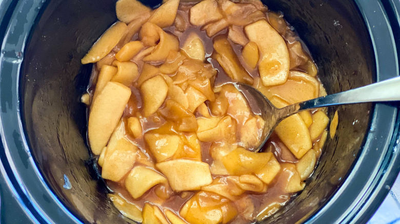 Cooked apple slices in a slow cooker