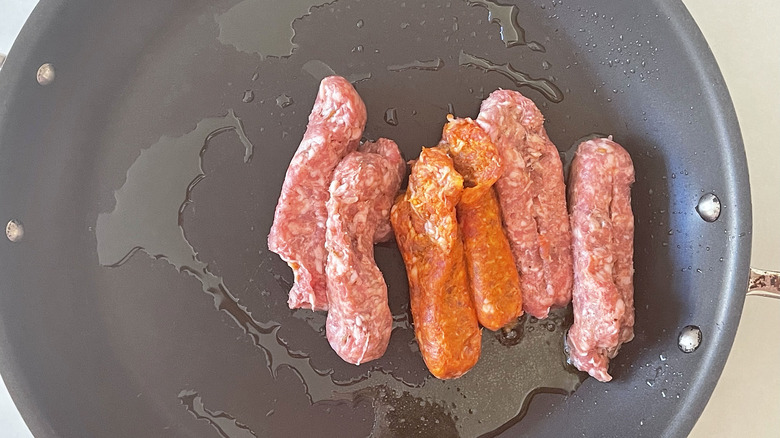 sausages cooking in pan