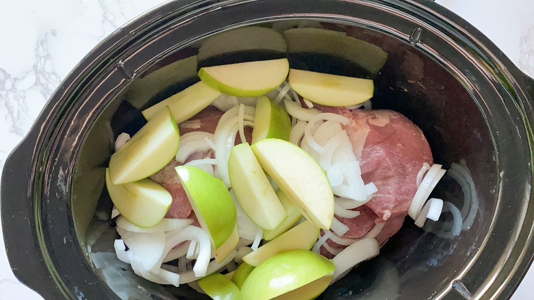 Ingredients for slow cooker pork with sauerkraut and apples in the slow cooker