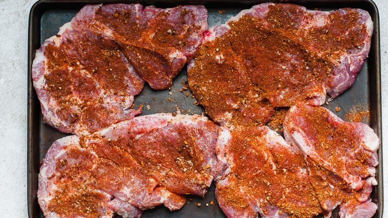 tray with spice rubbed pork steaks