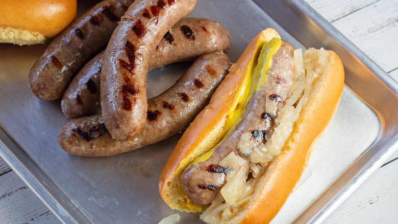 Bratwurst and bun on tray