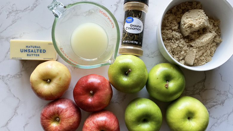 Apples, cinnamon, butter, sugar, and lemon juice on counter