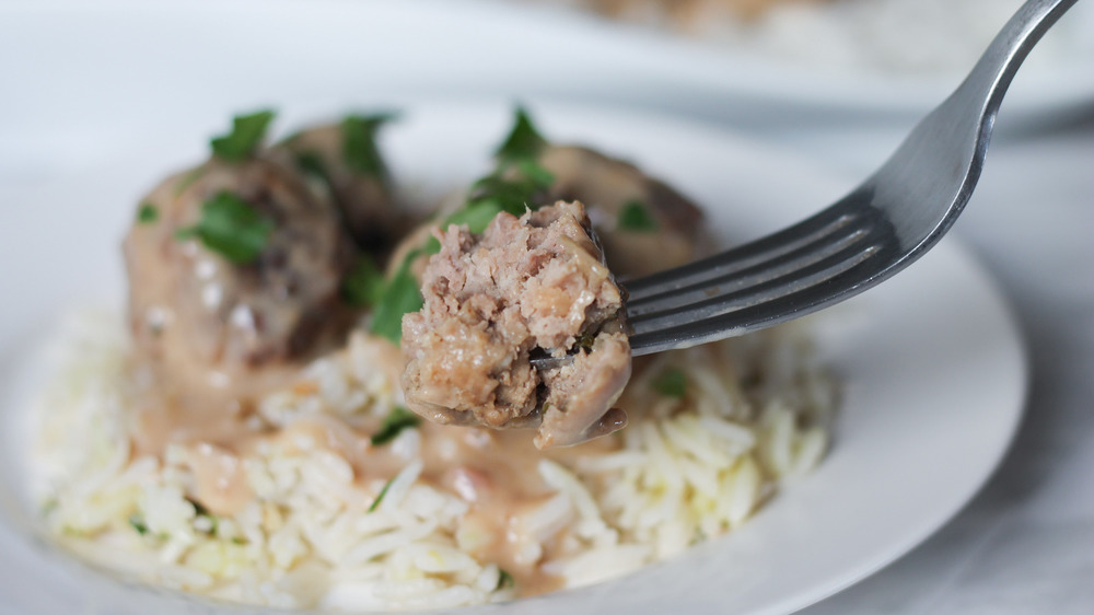 slow cooker Swedish meatballs being eaten