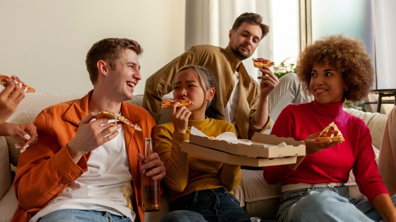 friends eating pizza at home