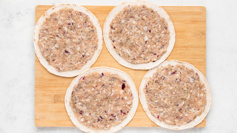 Tortillas spread with ground chicken mixture