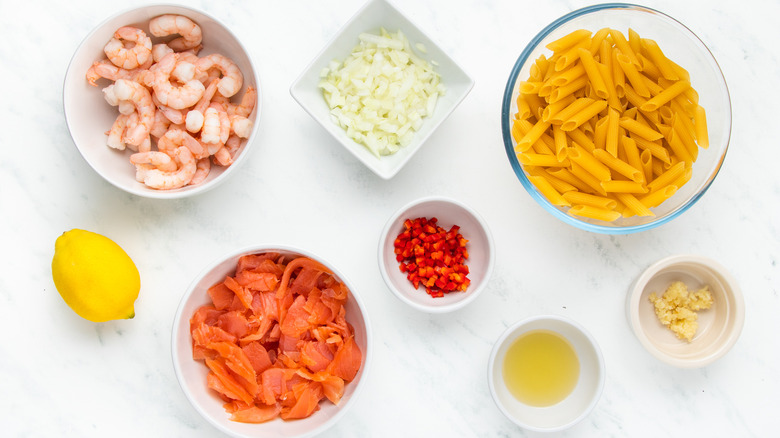 Smoked salmon and shrimp pasta ingredients in bowls