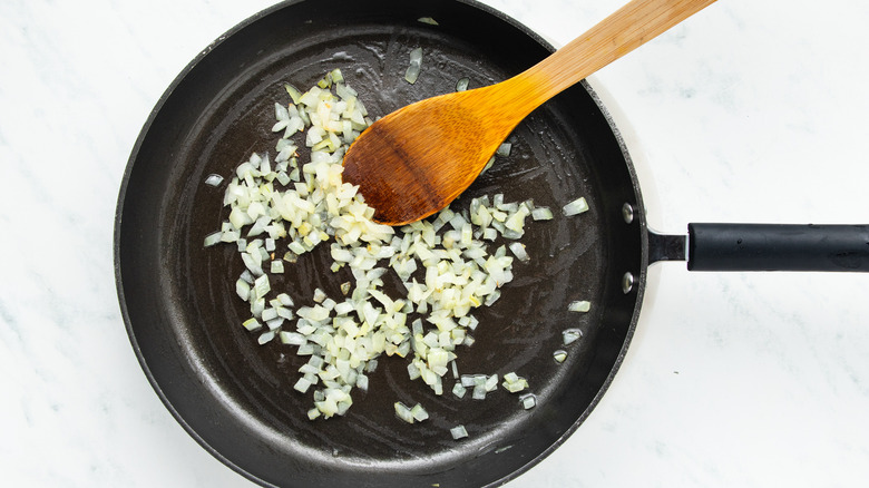 Diced onion frying in pan