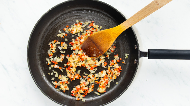 Onion, garlic and chili frying in pan