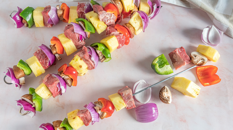 assembling steak kabobs with veggies