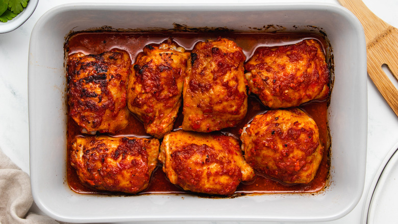 harissa chicken thighs in baking dish