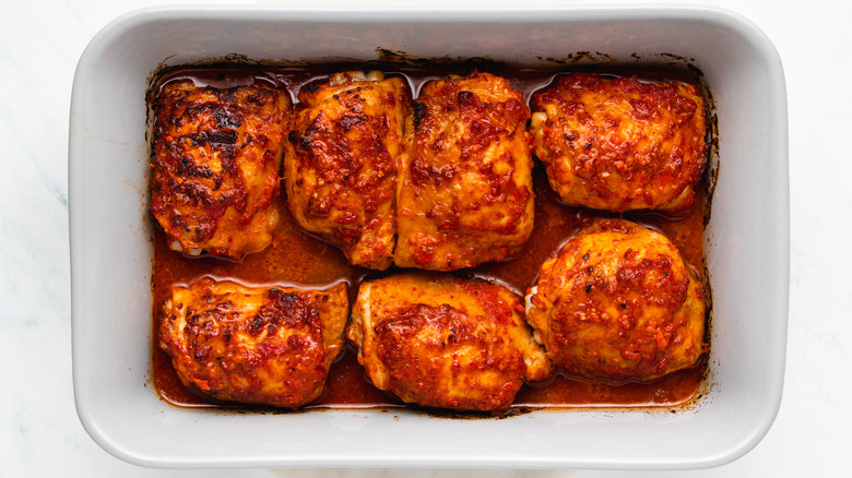 harissa chicken thighs in baking dish