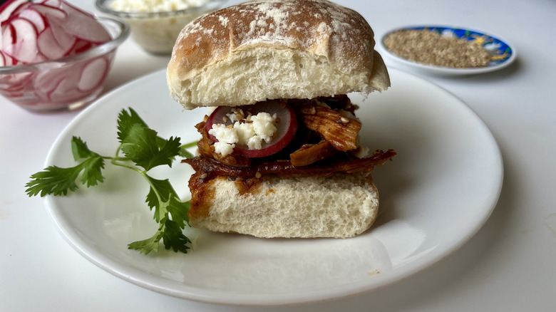 shredded chicken on bread roll