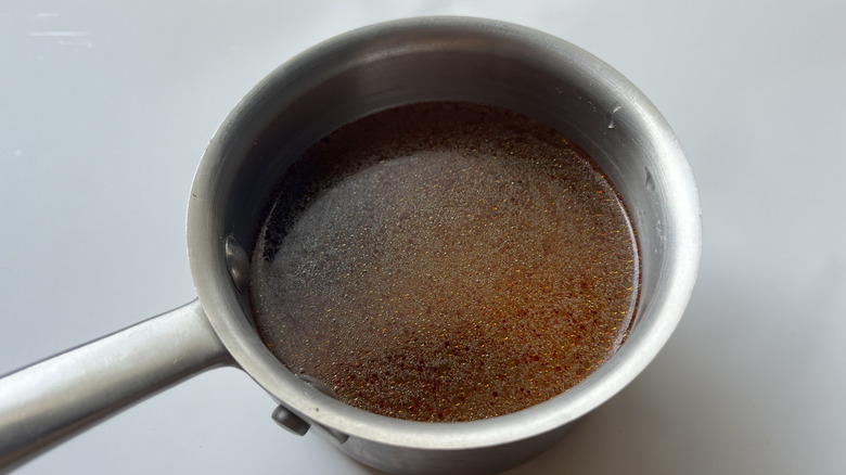 brown liquid in metal pot