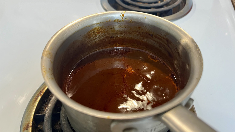 brown liquid in metal pot