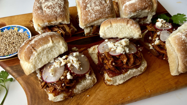 shredded chicken on bread rolls