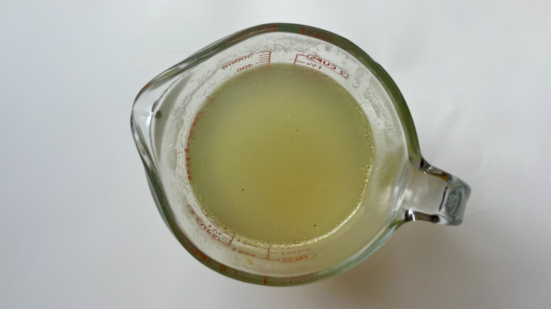 chicken broth in measuring cup