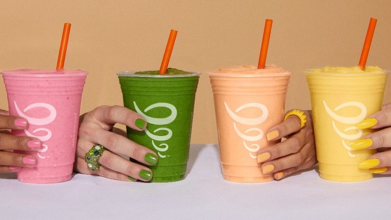 four hands holding Jamba drinks