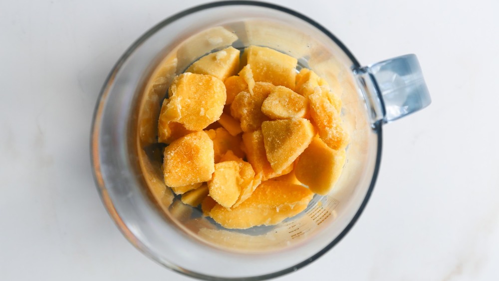 mango in blender for smoothie bowl