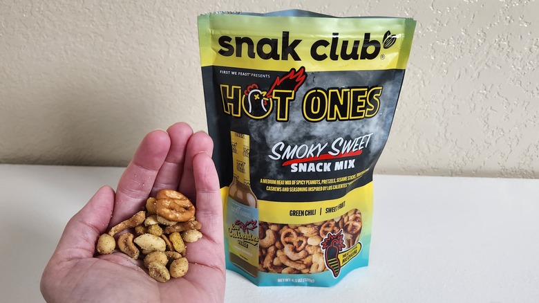 bag and hand holding snack mix