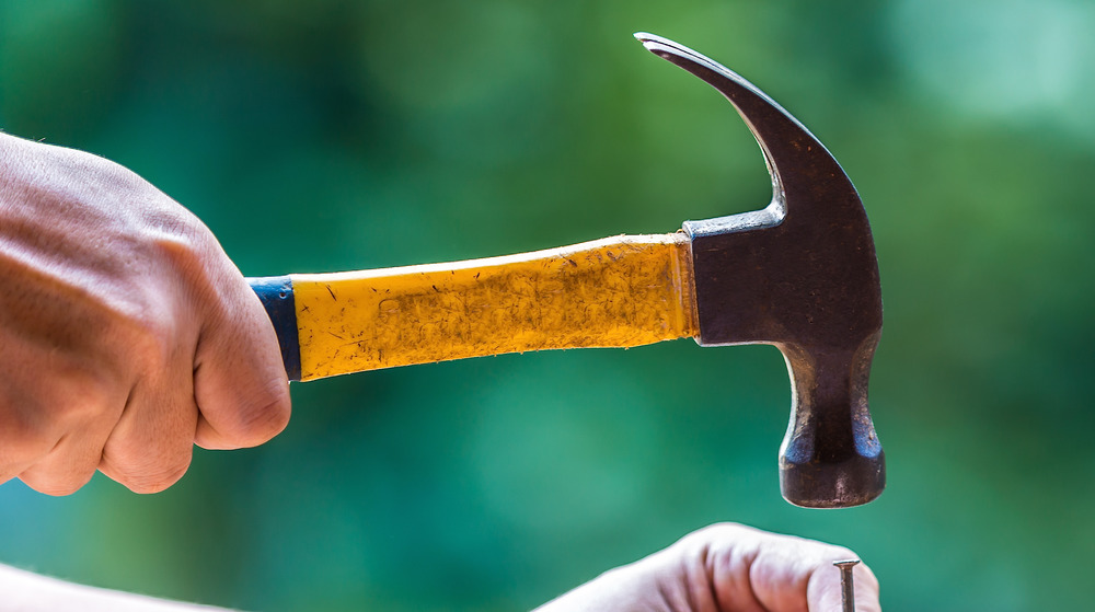 Hand with hammer from dollar store