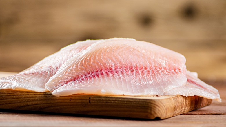 White fish fillets on a cutting board