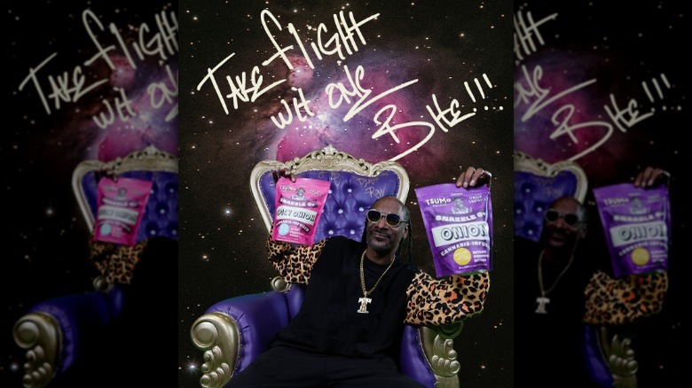 Snoop Dogg poses with snacks