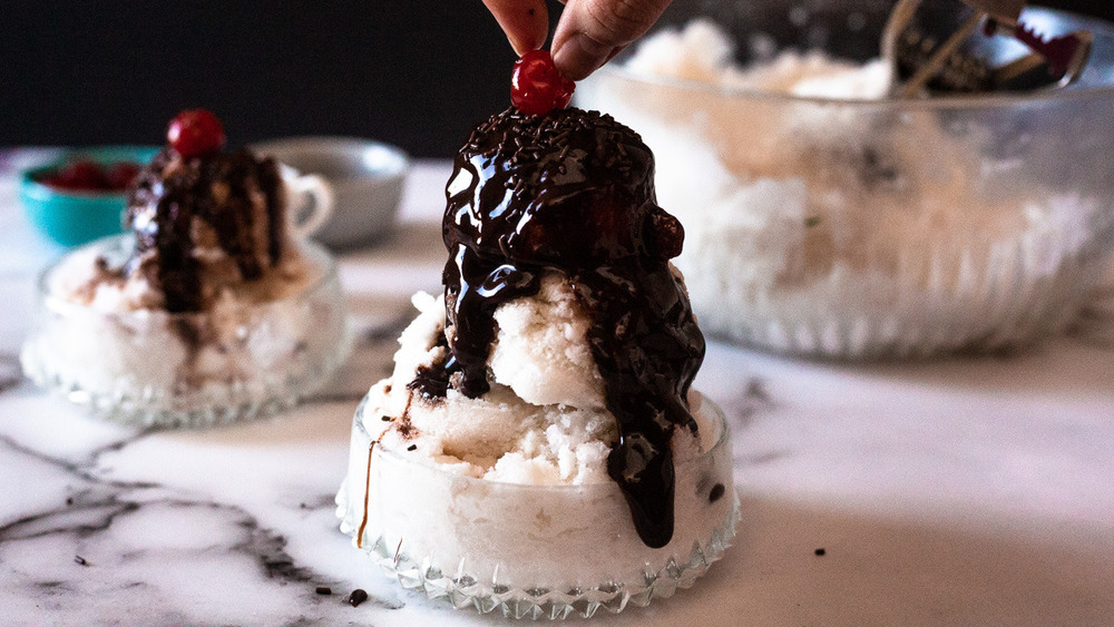 snow ice cream served with chocolate and cherry