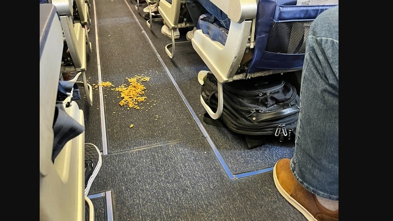 Pile of yellow rice on the floor or plane aisle