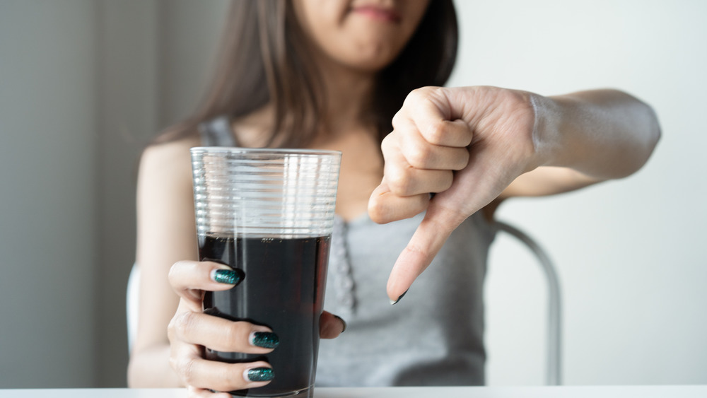 Woman expressing disapproval of diet soda