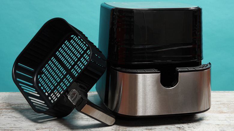 A can of cleaner being used on air fryer basket