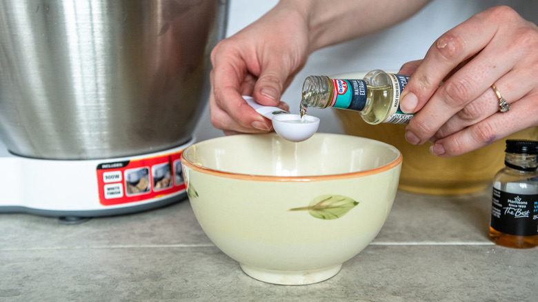 adding wet ingredients to bowl