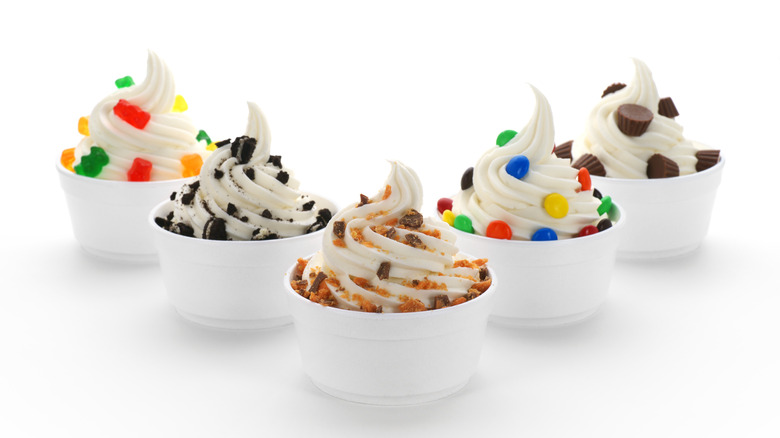 Various bowls of soft serve with toppings