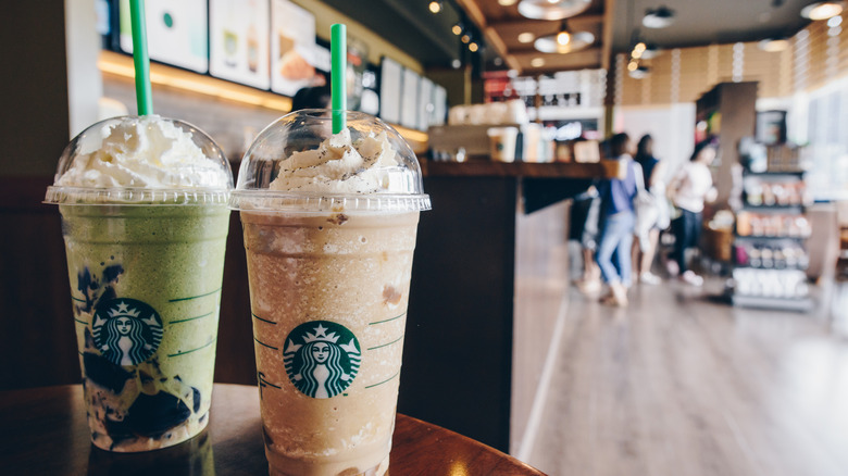 Two Starbucks drinks on table