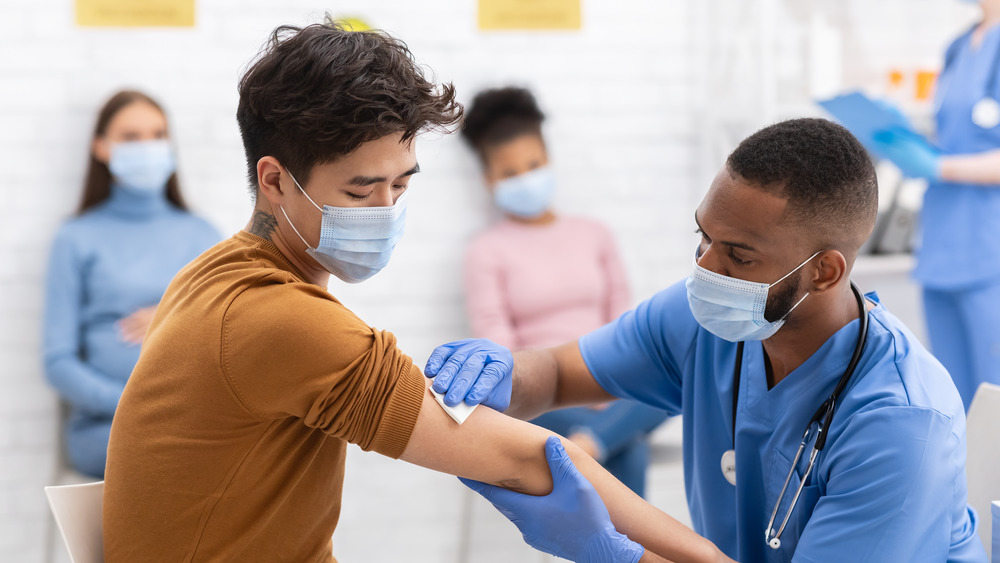 Medical worker giving person a vaccination