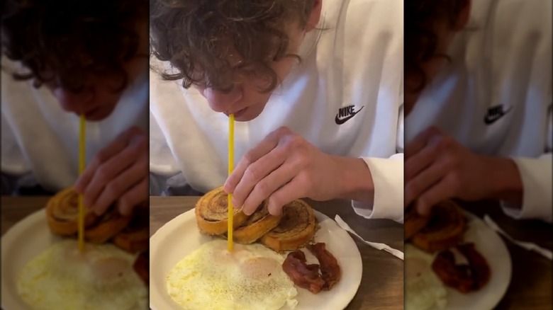 Person in a white shirt drinking eggs