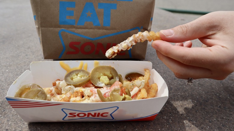 hand holding loaded Sonic fry