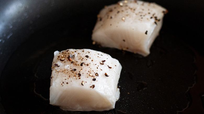 fish fillets cooking in pan