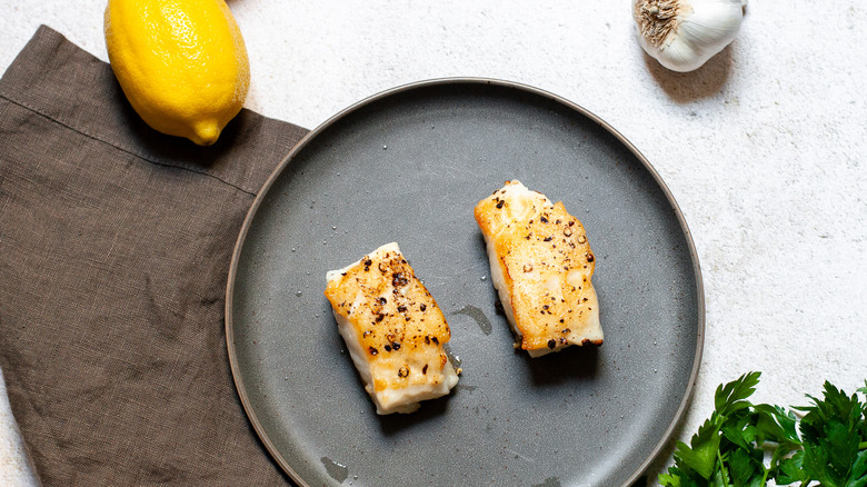 fish filet with lemon, garlic, and parsley