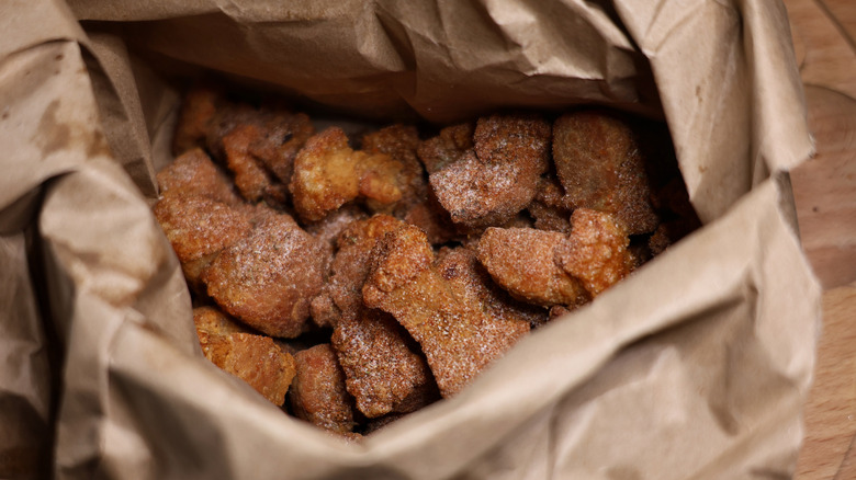 Paper bag full of seasoned pork cracklins