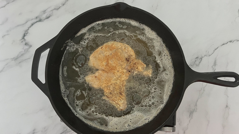 southern fried pork chop in skillet 