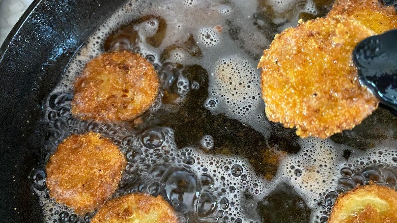 frying dredged squash in oil