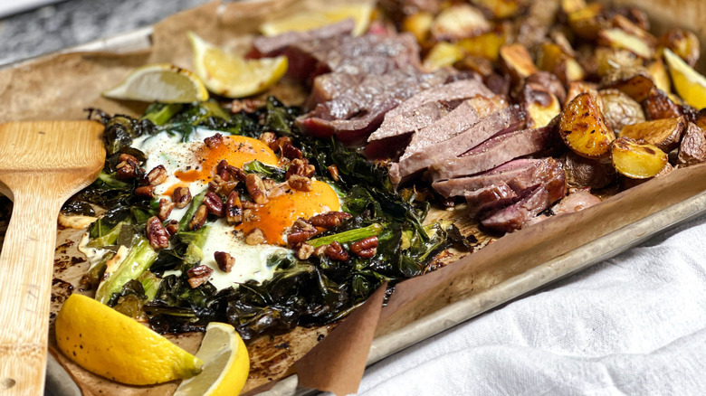 Sheetpan brunch with collards, eggs, steak, and potatoes