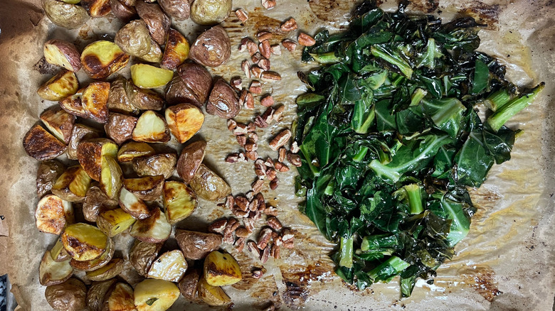 Potatoes, pecans, and collard greens on baking sheet