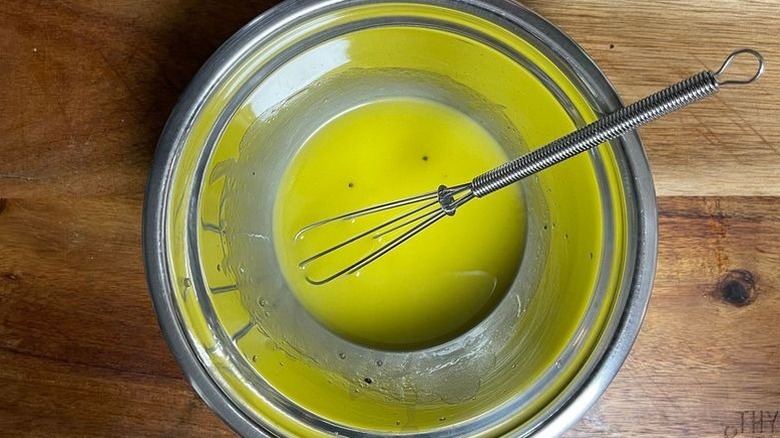 Dressing and small whisk in bowl