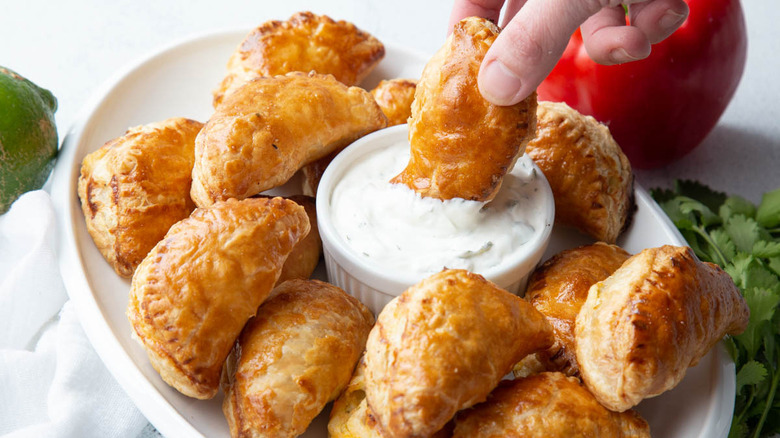 dipping empanada in sour cream 